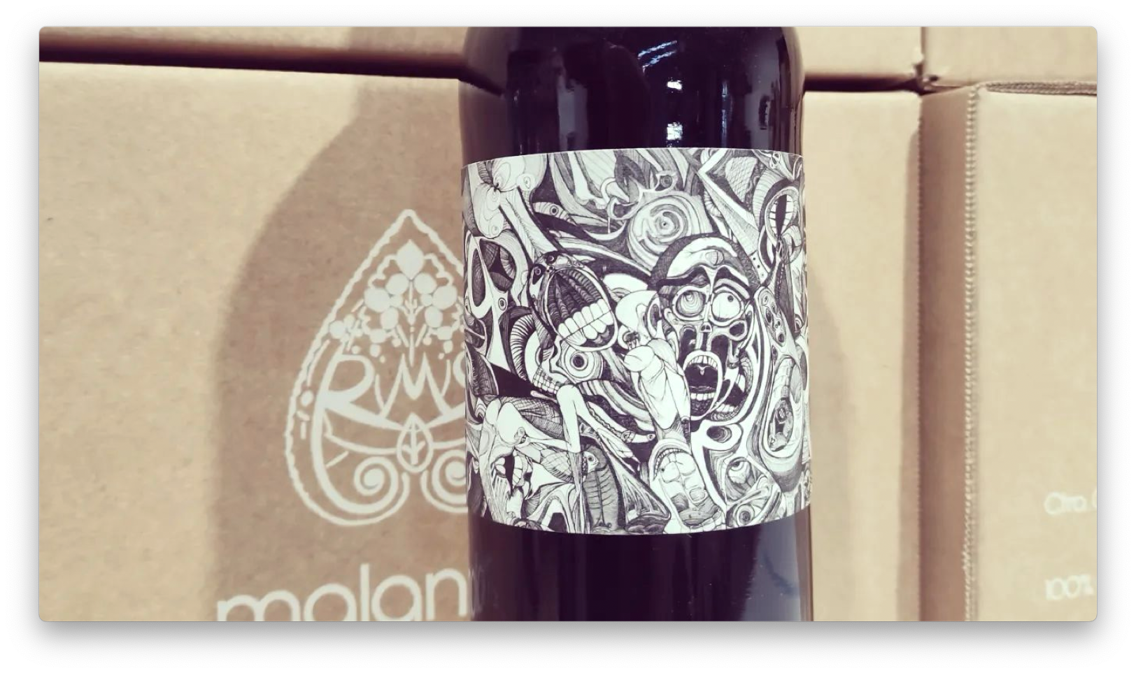 Slide showing the bottle for Malandrín superior in front of some boxes